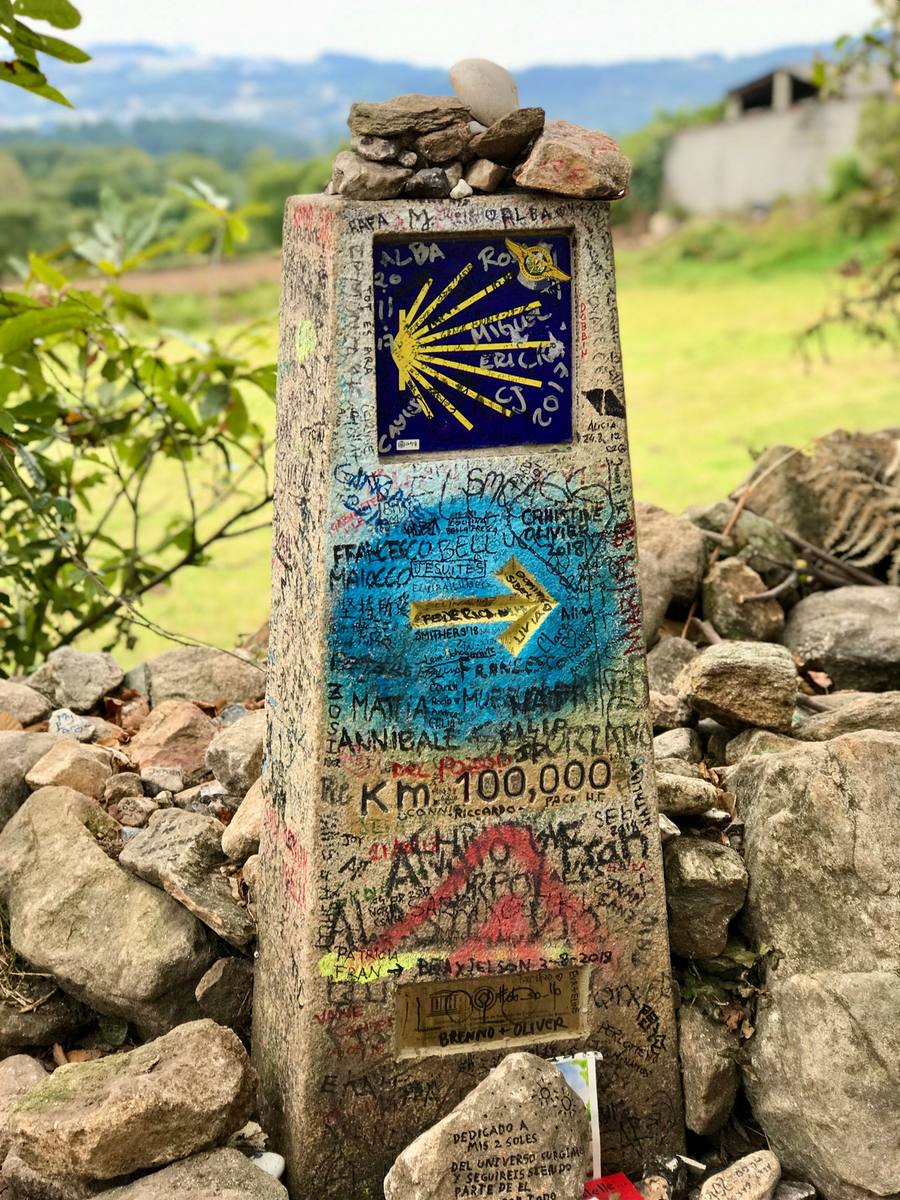 Yellow arrow waymark guiding pilgrims along the Camino Portugues