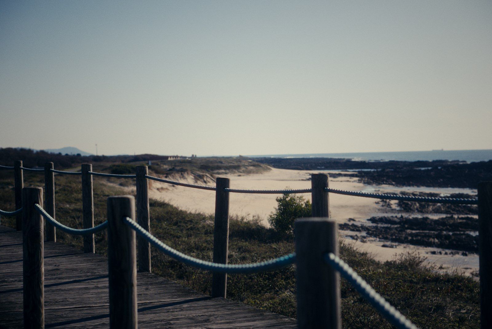 Wooden boardwalk running along a sandy Atlantic beach near Viana do Castelo on the Coastal Camino Portugues, northern Portugal