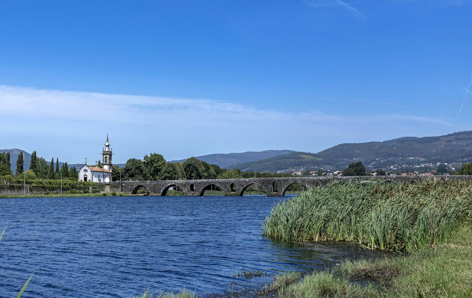 The medieval bridge of Ponte de Lima spanning the Rio Lima, with the church on the far bank, a classic Camino Portugues stage stop