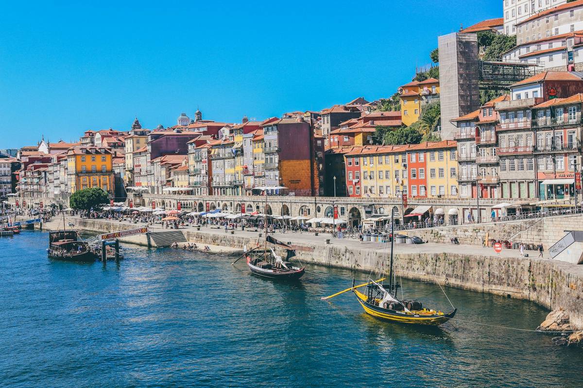Boats moored along the colourful Ribeira riverfront in Porto, Portugal, where most pilgrims begin the Camino Portugues