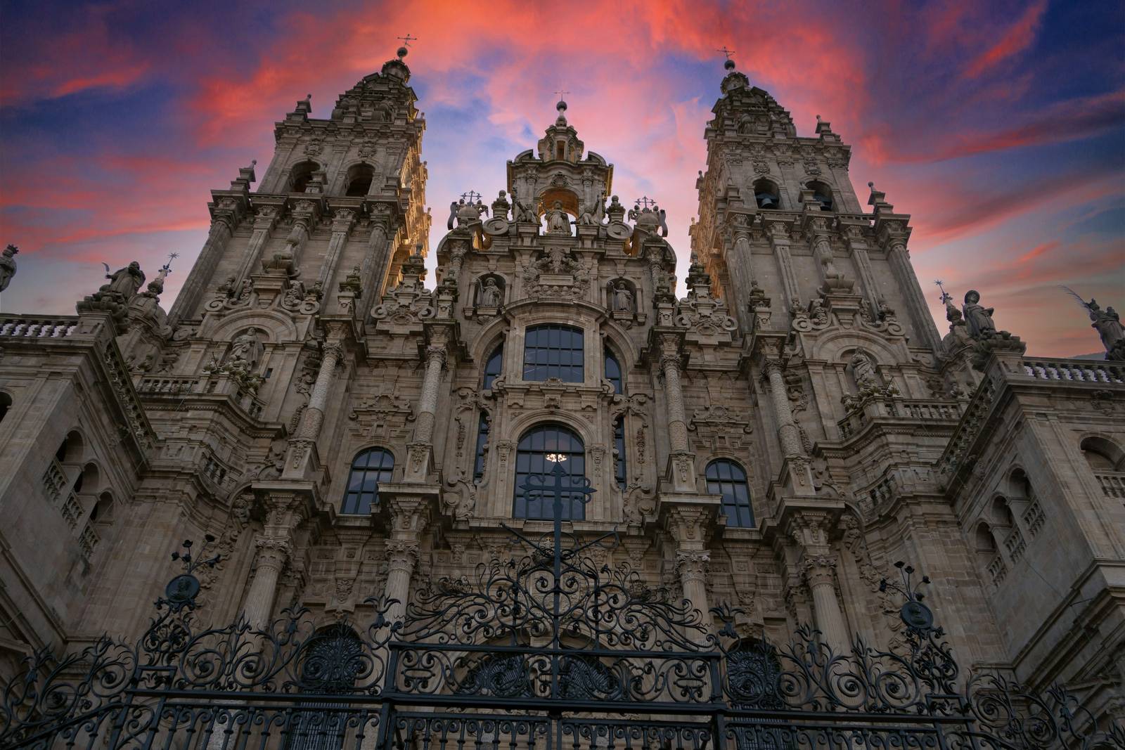 Stone facade of Santiago de Compostela cathedral rising against a bright sky