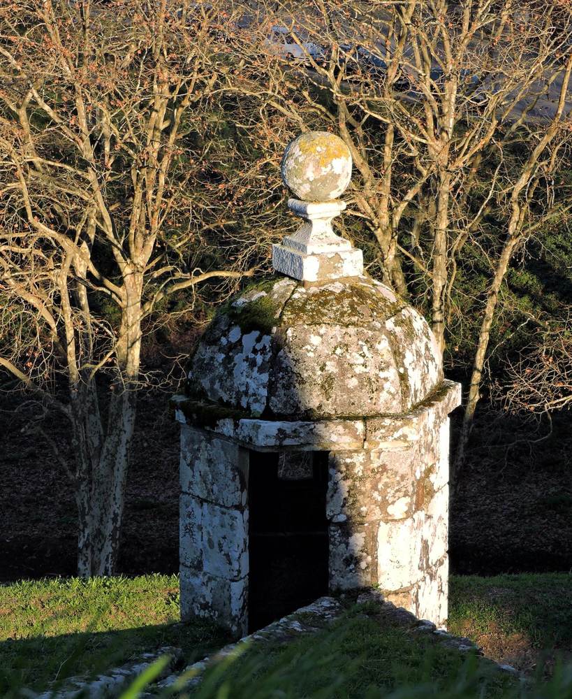 Historic stone fortification among bare trees inside the fortress of Valenca do Minho, Portugal